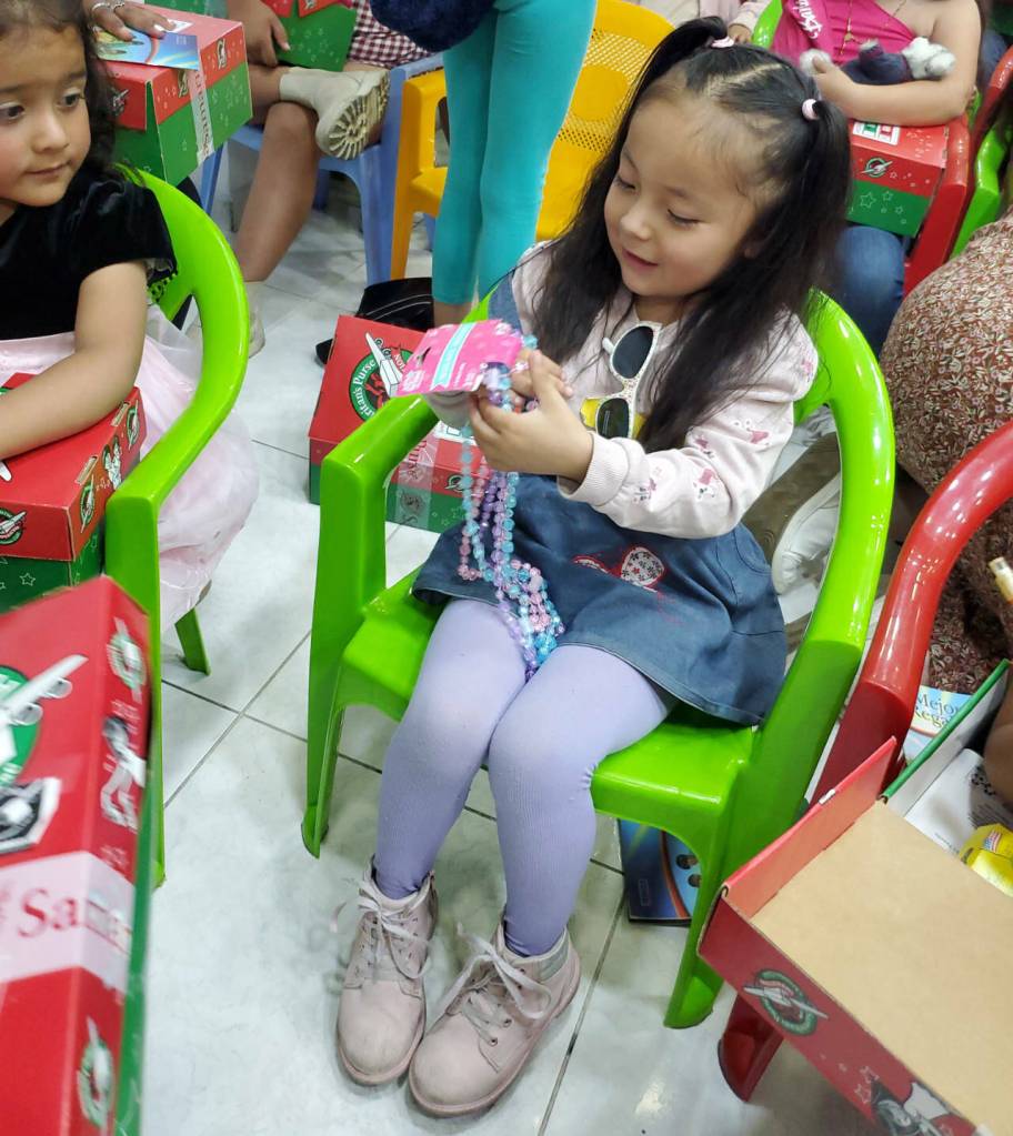Photo courtesy of Operation Christmas Child / A young girl in Quito, Ecuador, opens her Operation Christmas Child shoebox.