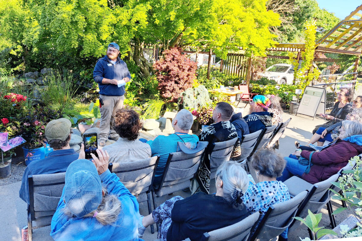 Stew Cockburn, from New Dungeness Nursery in Sequim chats with guests during an event at the nursery. When I think of all the gardens Ive ever been in, if enhancing human well-being wasnt the goal, I dont know what is, Stew says.