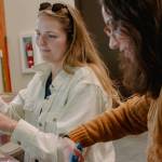 Sequim Gazette photo by Elijah Sussman / Environmental educator Jordan Higgins, left, and education manager Montana Napier demonstrate eco-brick building process at Dungeness River Nature Center in late June.