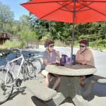 Phpto by Keith Thorpe/Olympic Peninsula News Group
Twyla and Doug Falsteisek, who split their time between Port Angeles and Sun City West, Ariz., take a break from their bike ride on the patio of the Dungeness River Nature Center along the Dungeness River in Sequim on July 10. The couple took advantage of summer weather for an excursion on the Olympic Discovery Trail.