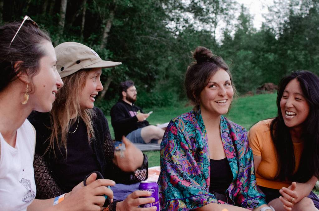 Sequim Gazette by Elijah Sussman / Attendees (from left) Amelia Depue, Angela Schnelle, Dani Carson, and Theresa Kim enjoy golden hour before before Kate Davis on July 6.
