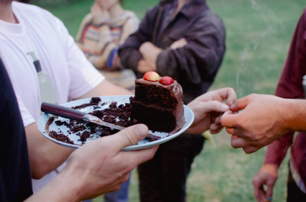 Sequim Gazette photo by Elijah Sussman / Following set, Pistil band members invite the audience to join in wishing their guitarist Matt Mkay a happy birthday on the stage. Afterward, band friends shared cake and cigarettes.
