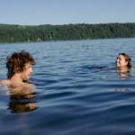 Sequim Gazette photo by Elijah Sussman / Taking a break from Tarboo Fest, Jammin Salmon fiddler Joey Gish and vending ceramicist Parker Anderson made the short drive down to Linger Longer to cool down in a jellyfish-filled inlet on July 5.