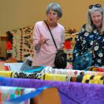 Sequim Gazette photo by Matthew Nash
Neighbors Dawn Harris and Suzy Morse of Sequim look at the 160-plus quilts inside Trinity United Methodist Church on July 20 during the Sunbonnet Sue Quilt Clubs annual show. The event moved to the church after being a one-day event outside at Pioneer Memorial Park.