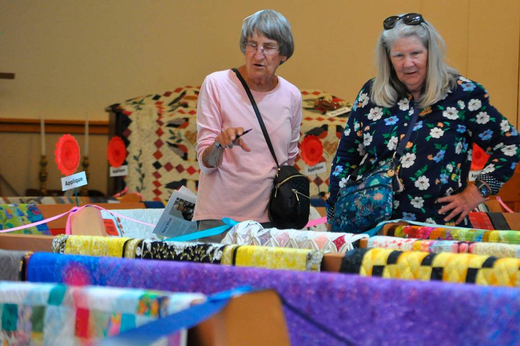 Sequim Gazette photo by Matthew Nash
Neighbors Dawn Harris and Suzy Morse of Sequim look at the 160-plus quilts inside Trinity United Methodist Church on July 20 during the Sunbonnet Sue Quilt Clubs annual show. The event moved to the church after being a one-day event outside at Pioneer Memorial Park.