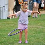 Sequim Gazette photo by Matthew Nash/ Lucy Willis, 3, of Bremerton tries out her hula hoop while walking with fresh face paint at the Sequim Lavender Festival in the Park on July 21.
