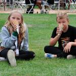 Harley Rae, 8, and Rowen, 7, Smith of Port Angeles enjoy some ice cream at the Sequim Lavender Festival in the Park. Their dad Ryan said they come every year for the food, ice cream and music.