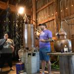 Sequim Gazette photo by Michael Dashiell / B&B Family Farm co-owner Zion Hilliker explains production of the farms products to visitors during Lavender Weekend on July 20.