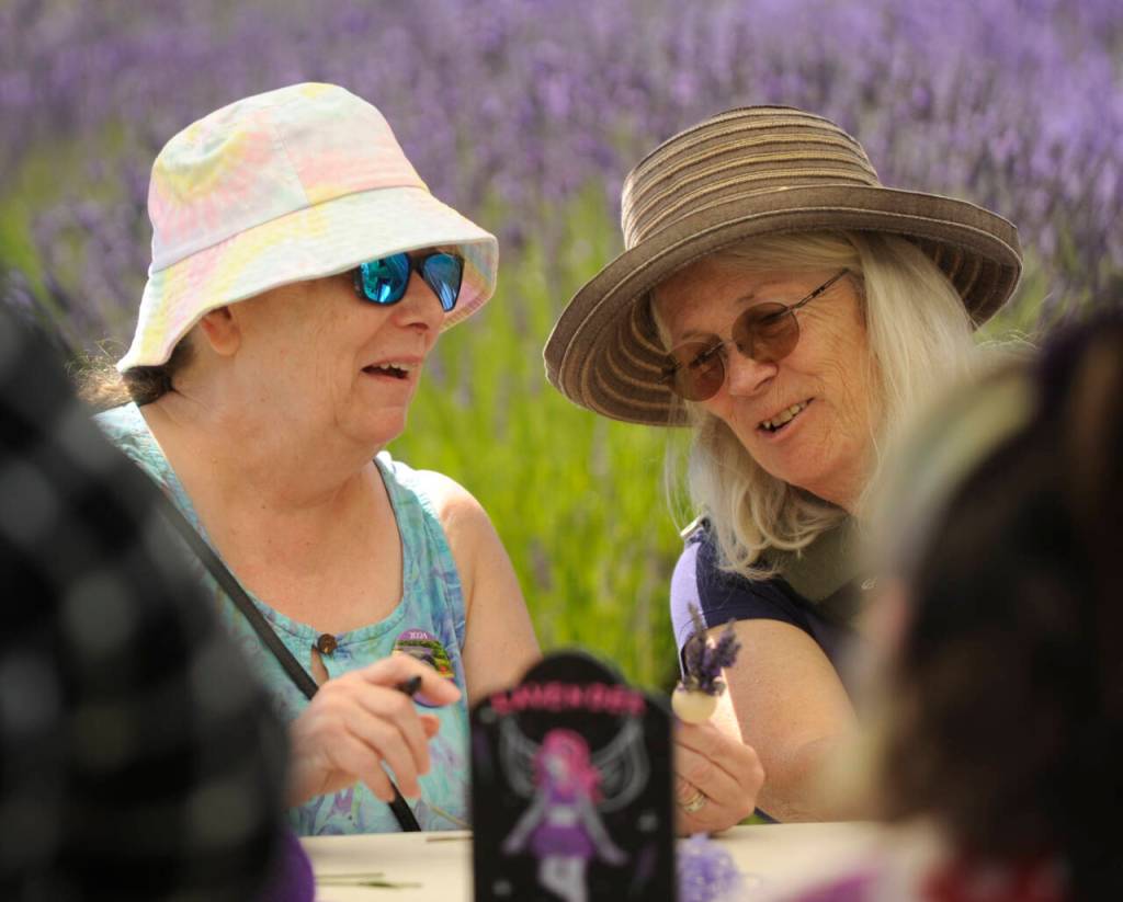 Sequim Gazette photo by Michael Dashiell / Tami Ruby, left, of Chimacum, and Susan Fuller of Sequim enjoy making lavender wands at Jardin du Soliel Lavender Farm & Gift Shop on July 19.