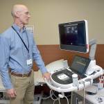 Olympic Medical Heart Center director Leonard Anderson examines a new echocardiograph at the Port Angeles hospital facility. (Keith Thorpe/Peninsula Daily News)