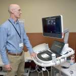 Photo by Keith Thorpe/Olympic Peninsula News Group / Olympic Medical Heart Center director Leonard Anderson examines a new echocardiograph at the Port Angeles hospital facility.
