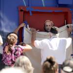 Sequim Gazette photo by Michael Dashiell / American Legion post Commander Carl Bradshaw and Sequim artist Melissa Klein unveil the portrait of Jack Grennan as Holly Rowan, president of the Clallam County Veterans Association, looks on at the July 20 unveiling of the Legions Remember Me mural.