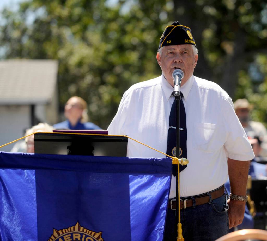 Sequim Gazette photo by Michael Dashiell / American Legion post Commander Carl Bradshaw speaks at the unveiling of the Remember Me mural in Sequim on July 20.