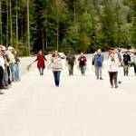 Lower Elwha Klallam Tribal Chairwoman Francis Charles leads tribal members in a ceremony across the length of the new Elwha River bridge, which opened Sunday afternoon. The tribal members dedicated the surface with cedar bows as members of the bridge crew watched from left. (Dave Logan/for Peninsula Daily News)