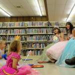 Sequim Gazette photo by Matthew Nash/ Sequim Gazette photo by Matthew Nash/ Sequim Irrigation Festival royalty, from left, princess Sophia Treece, princess Kailah Blake, and queen Ariya Goettling, enjoy a fun moment with dressed-up participants at Storytime with the Royalty. Not pictured is fellow princess Ashlynn Northaven.