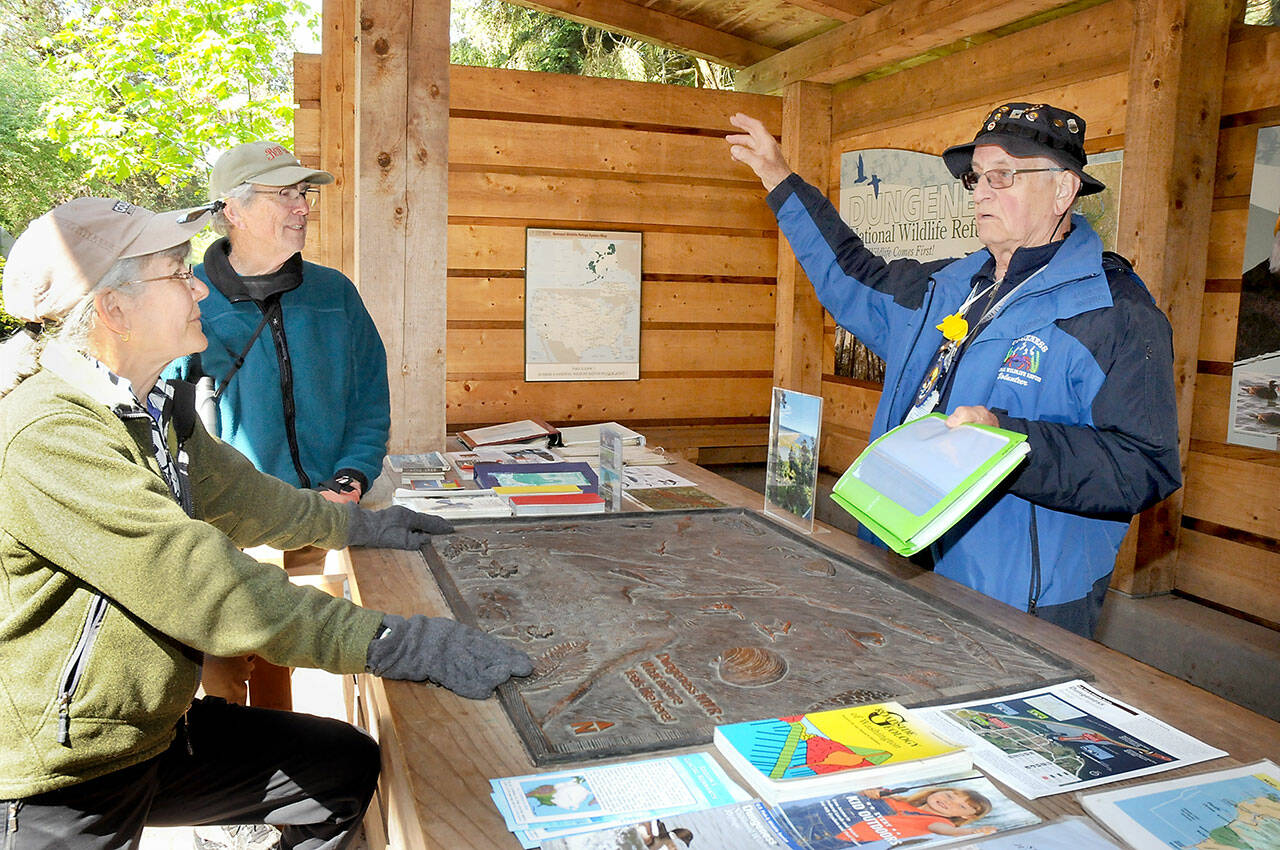 File photo by Keith Thorpe/Olympic Peninsula News Group
Martin Gutowski, a volunteer with the Dungeness National Wildlife Refuge, right, discusses features and attractions of the North Olympic Peninsula with Jan and Bob Tivel of Anacortes at the refuges information kiosk northwest of Sequim in May 2023. Besides being a sanctuary for birds and other wildlife, the refuge serves as gateway to the Dungeness Spit and the New Dungeness Lighthouse.