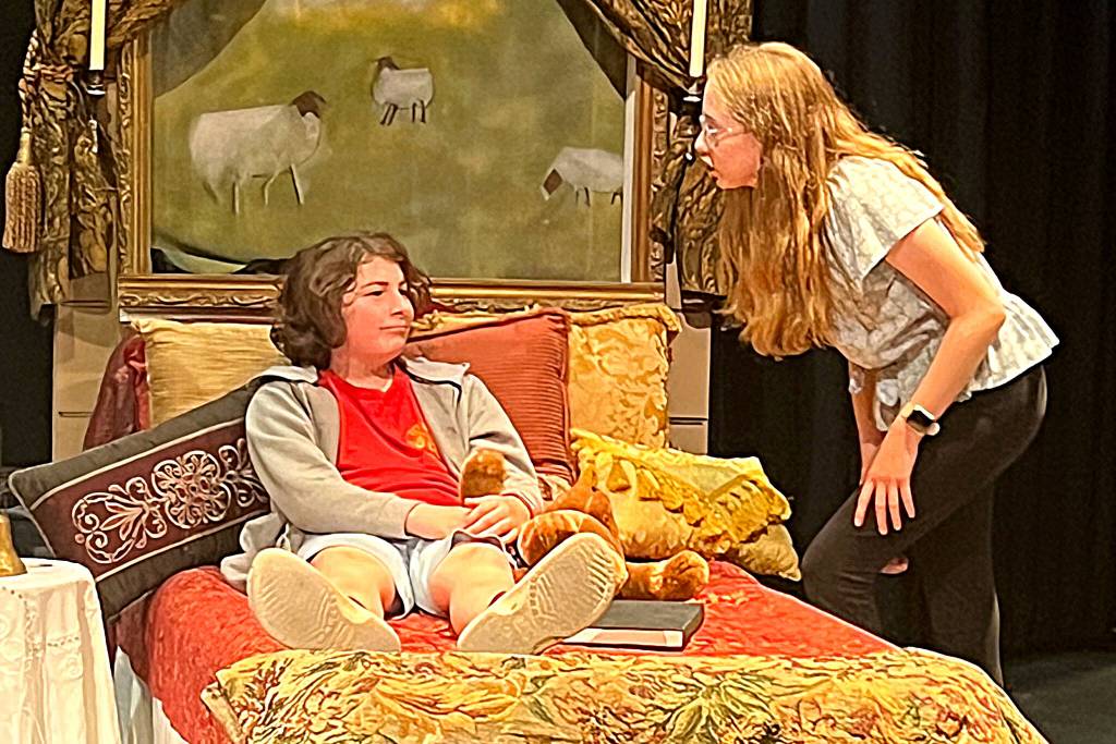 Photo courtesy Olympic Theatre Arts/ Mary Lennox (Trinity Devlin) talks to the Colin Craven (Pace Struve) from his bed side in a scene from The Secret Garden.