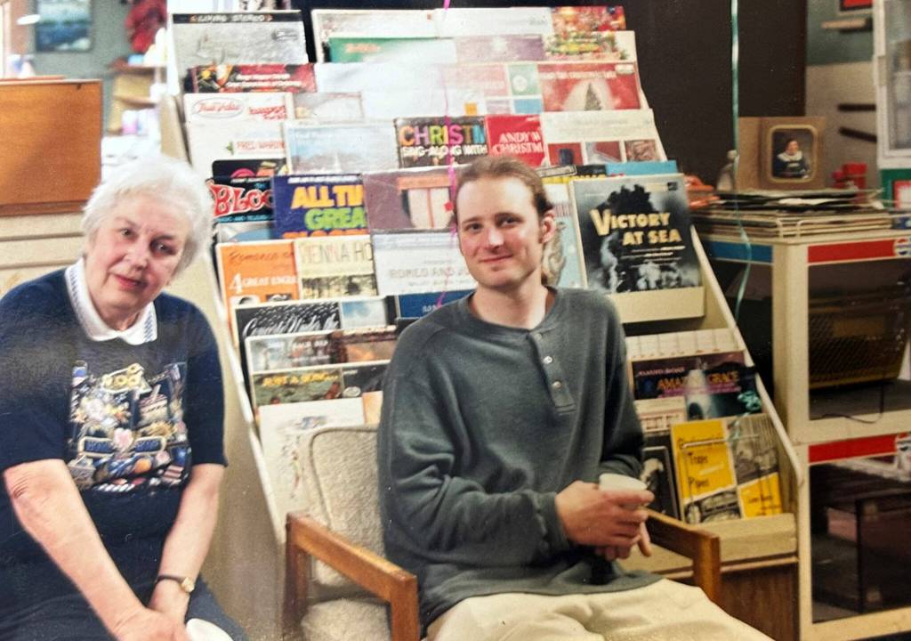 Photo courtesy Carlsborg Store
Current co-owner Justin Pollack of the Carlsborg Store sits with former owner Jeanne Stevenson in 2000 at a retirement party. He never imagined hed purchase and operate the store he grew up going to for penny candy.