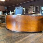 Sequim Gazette photo by Matthew Nash/ One centerpiece of the Carlsborg Store is its original front counter that Justin Pollak restored after it was covered in carpet, linoleum and fence boards.