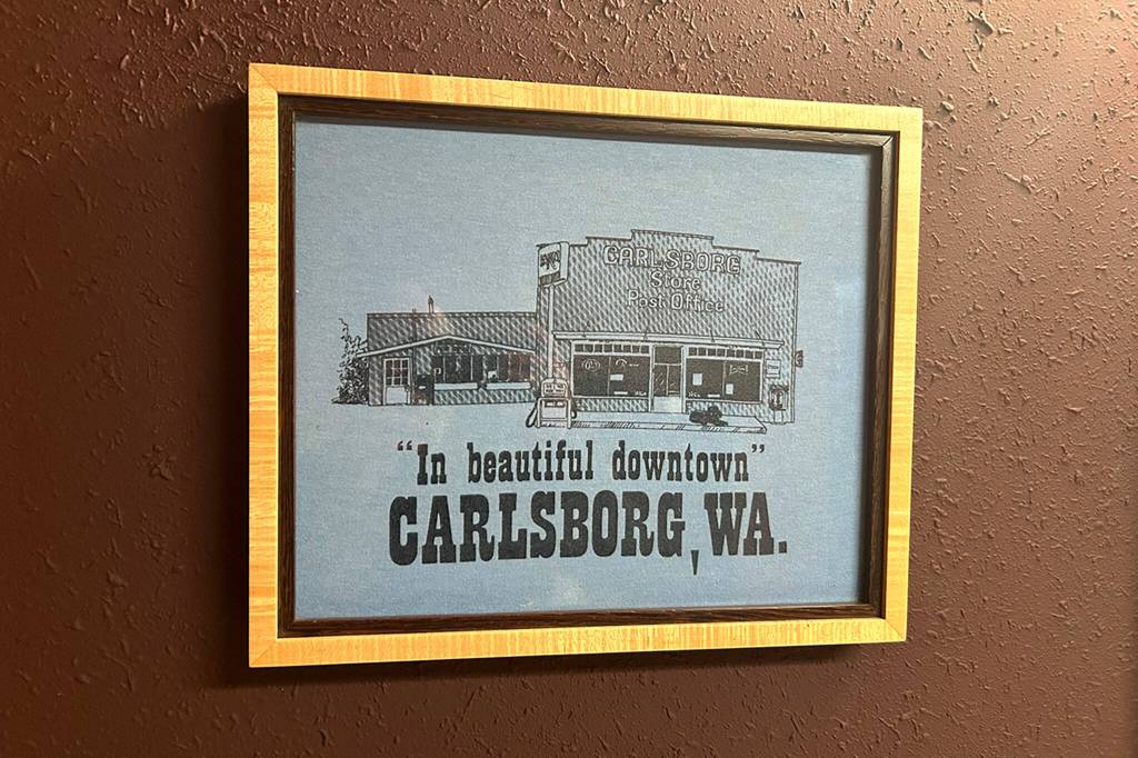 Sequim Gazette photo by Matthew Nash/ In one of the bathrooms of the Carlsborg Store is a framed t-shirt from decades ago.