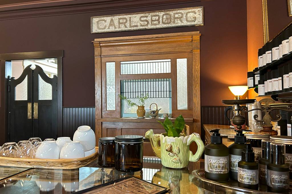 Sequim Gazette photo by Matthew Nash/ The Carlsborg Store features the original train depot sign along with daily organic tea tastings.