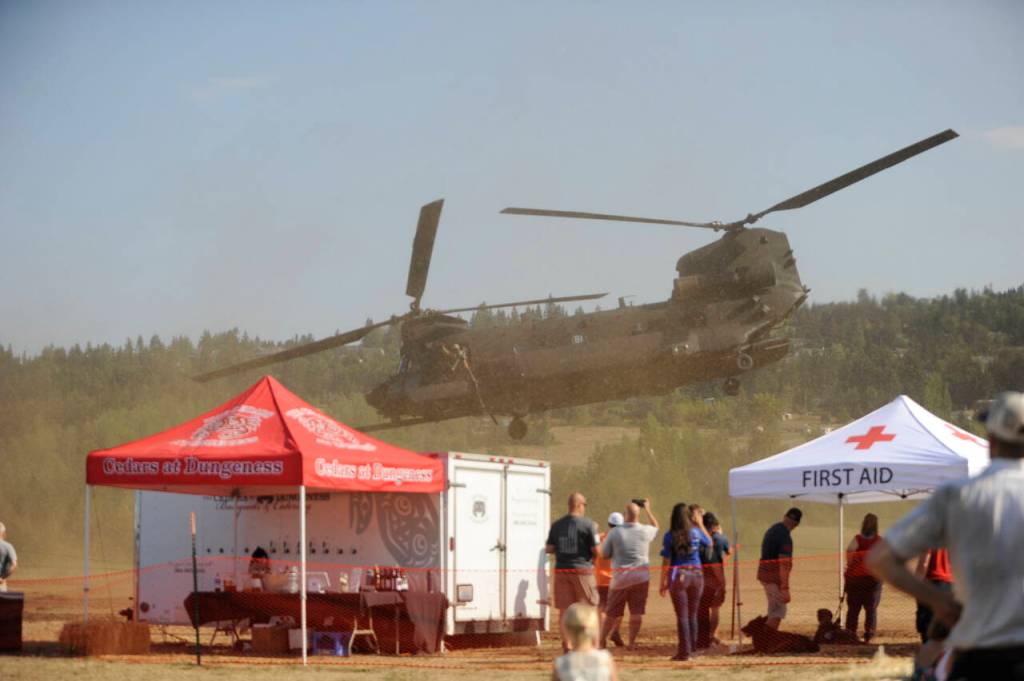 Sequim Gazette photo by Michael Dashiell / An MH-47G Chinook, a U.S. Army twin-engined, tandem rotor helicopter, takes off from the Unity of Effort event in Sequim on Aug. 10.