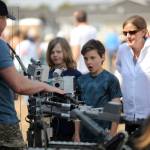 Sequim Gazette photo by Michael Dashiell / Miles Angelovic, 10, and Charlie Stewart, 11, both of Sequim learn about bomb disposing technology from Andre Gele, a U.S. Navy Explosive Ordnance Disposal bomb technician, at the Unity of Effort event in Aug. 10.