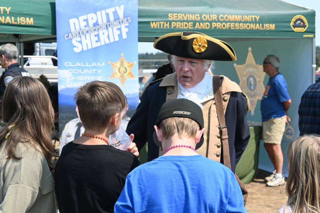 Sequim Gazette photo by Michael Dashiell / George Washington (Very Frykholm of Sequim) speaks with youths attending the Unity of Effort event in Aug. 10.