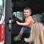 Sequim Gazette photo by Michael Dashiell / Walker Miller, 2, of Port Angeles, enjoys some time behind the wheel of a Clallam County Fire District 3 truck at the Unity of Effort event in Aug. 10.4col