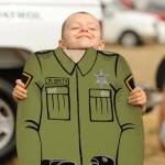 Sequim Gazette photo by Michael Dashiell / Daniel Derevianchuk, 5, of Port Angeles, looks for a growth spurt for his junior deputy role at the Unity of Effort event in Sequim on Aug. 10.