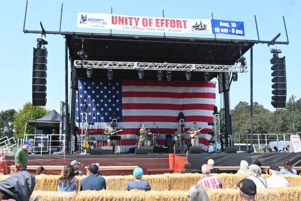 Sequim Gazette photo by Michael Dashiell / Evergreen Rock (U.S. Army) kicks off the live music at the Unity of Effort event in Sequim on Aug. 10.
