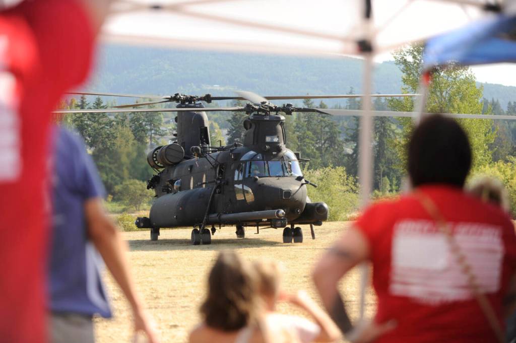 Sequim Gazette photo by Michael Dashiell / Attendees of the Unity of Effort event in Sequim on Aug. 10 get a look at an MH-47G Chinook, a U.S. Army twin-engined, tandem rotor helicopter.