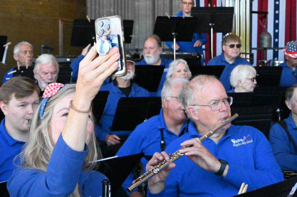 Photo by Richard Greenway/Sequim City Band / Sequim City Band members enjoy a moment during warm-ups at their Independence Day concert in July.