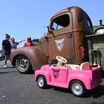 Sequim Gazette photo by Michael Dashiell / An event for vehicles great and small: This toy roadster is dwarfed by Damon McGuffs 1947 International KB-2 pickup. The truck was built in 47 days in memory of Lynie Staus, who died May 1 after a battle with cancer.