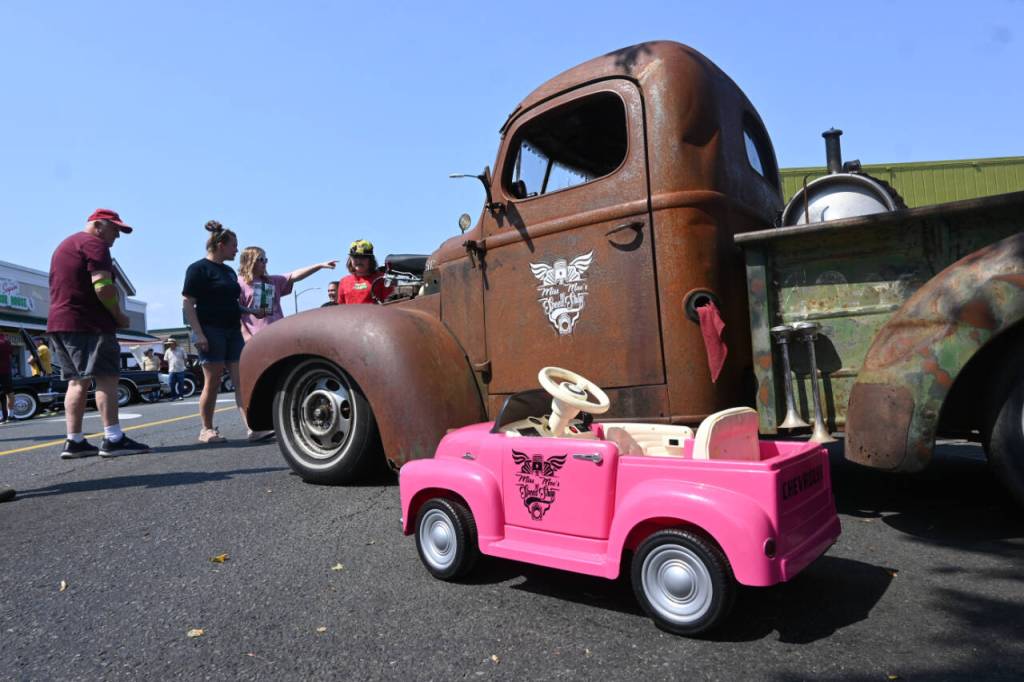 Sequim Gazette photo by Michael Dashiell / An event for vehicles great and small: This toy roadster is dwarfed by Damon McGuffs 1947 International KB-2 pickup. The truck was built in 47 days in memory of Lynie Staus, who died May 1 after a battle with cancer.
