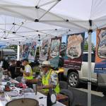 Sequim Gazette photo by Michael Dashiell / Organizers of the annual Sequim Prairie Nights meet with visitors in downtown Sequim on Aug. 10.