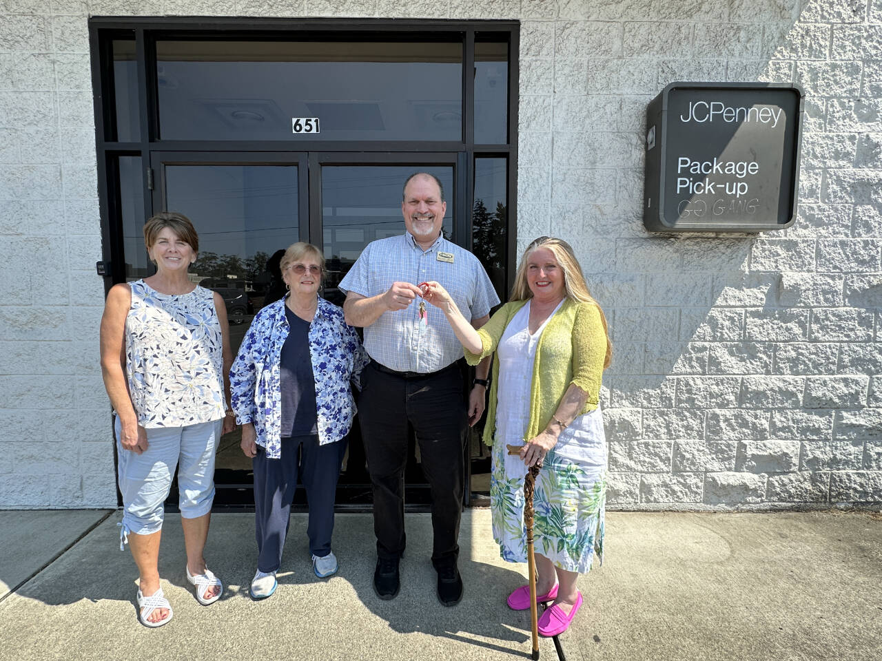 Photo courtesy of Shipley Center / Eileen Schmitz, JACE Real Estate owner and Shipley Center board member, presents the keys of the former JCPenney building at 651 W. Washington St. to Shipley Center executive director Michael Smith following the centers Aug. 8 purchase of the building. At far left is Joyce Gladen of JACE Real Estate, and second from left is Shipley Center board secretary Margaret Cox.
