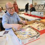 Sequim Gazette photo by Michael Dashiell / Robert Beall, a vendor from Portland, Oregon, sifts through stamps at the Strait Stamp Show at the Guy Cole Event Center on Aug. 10. Hosted by the Strait Stamp Society, whose members celebrated its 50th anniversary last year, the event features complimentary stamps for children, several door prizes, a penny stamp table, the postal service on site, dealers, exhibits and more each year. Stamp aficionado (and club member) Phil Castell said this years show drew about the same attendance as 2023.