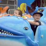 Photo by Keith Thorpe/Olympic Peninsula News Group
Above: Cevoun Anders, 5, of Port Angeles, left, and Brixton Dennis, 3, of Sequim take a ride on the Flying Fish amusement ride at the Clallam County Fair on Aug. 17 in Port Angeles.
