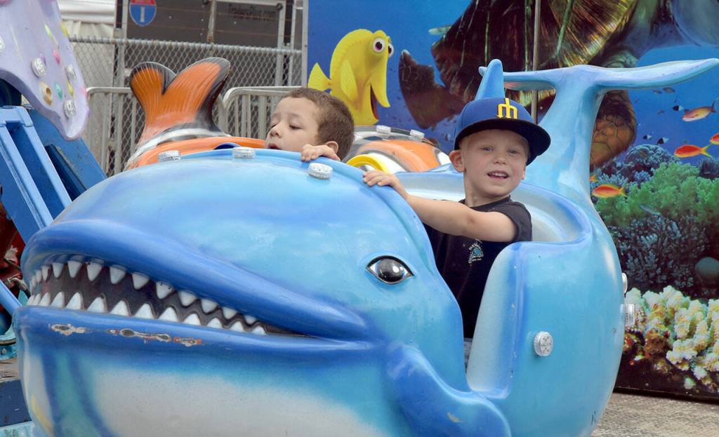 Photo by Keith Thorpe/Olympic Peninsula News Group
Above: Cevoun Anders, 5, of Port Angeles, left, and Brixton Dennis, 3, of Sequim take a ride on the Flying Fish amusement ride at the Clallam County Fair on Aug. 17 in Port Angeles.