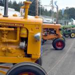 Photo by Keith Thorpe/Olympic Peninsula News Group / Ron Rottler and Tammi Moses, both of Port Angeles, examine a line of tractors on display at the Clallam County Fair on Aug. 17.