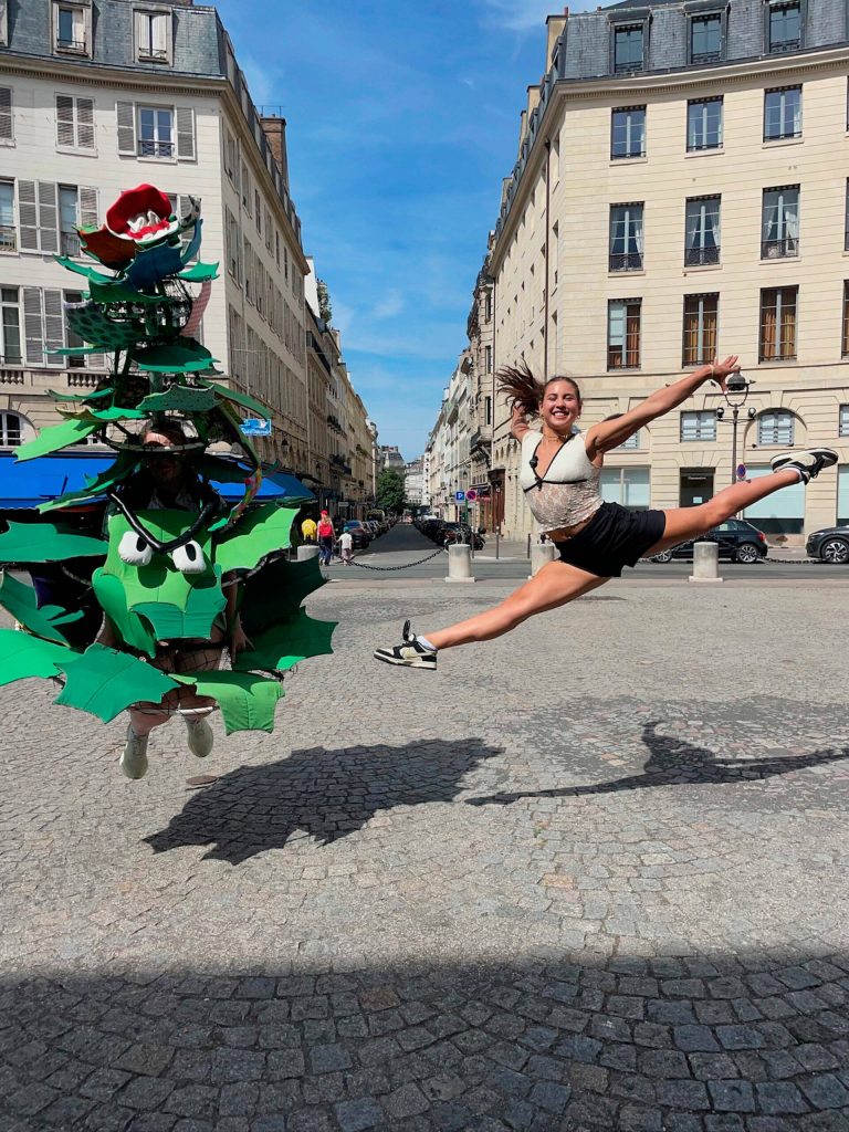 At right: The Stanford Tree (Coulson) and gymnast Levi Jung-Ruivivar, who competed for the Philippines womens gymnastics team and is an incoming Stanford freshman, jump together in Paris during an interview promoting the universitys many Olympians.