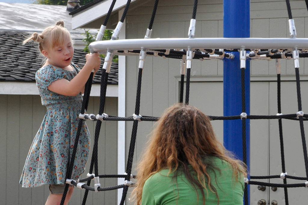 Nine-year-old Eliza Burrows enjoys a spin on the Cyclo Cone Climber tower at Olympic View Churchs The Gathering Ground. The structure holds up to 20 children and spins both directions.