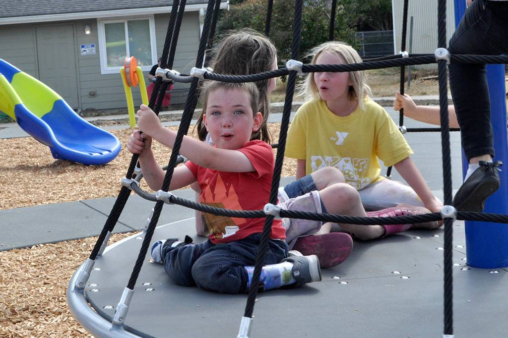 Sequim Gazette photo by Matthew Nash/ Five-year-old Boaz Saffold enjoys a ride inside the Cyclo Cone Climber on Aug. 16 during the soft opening for The Gathering Places first phase at Olympic View Church. The playground is open dawn to dusk to all community members.