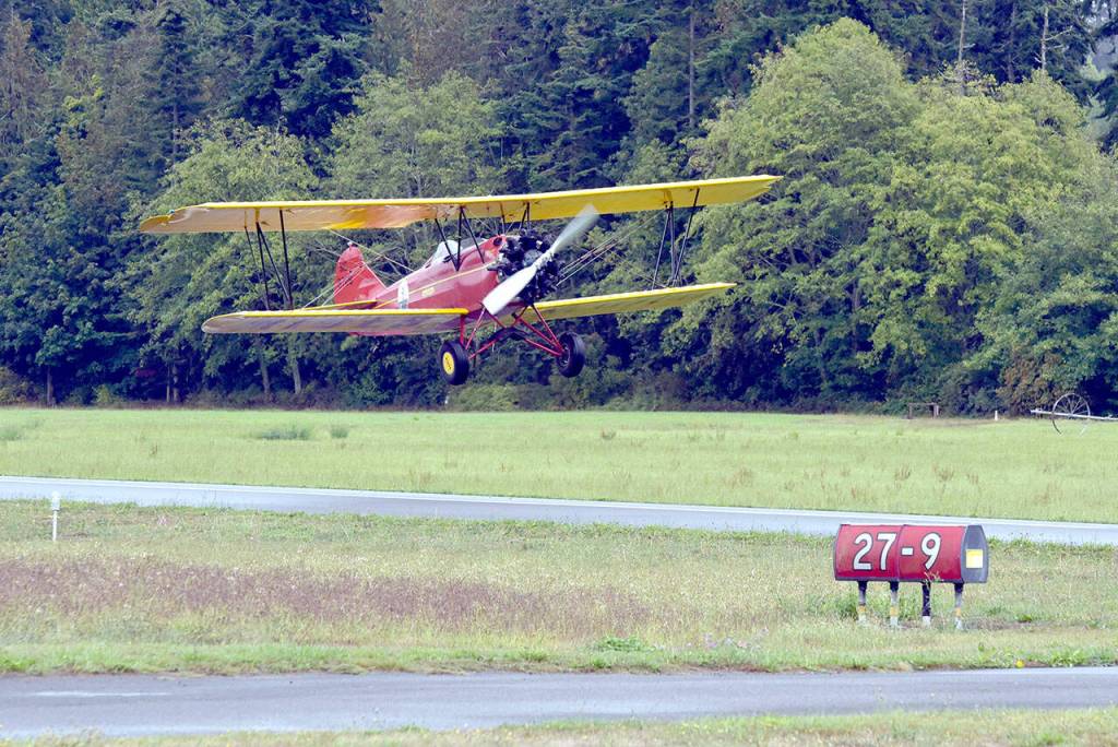 Photo by Keith Thorpe/Olymic Peninsula News Group / A Barnstormer 1929 Curtiss Wright Travel Air D-4000 takes off on Runway 27 at Sequim Valley Airport during the Air Affaire fly-in on Aug. 24 in Sequim.