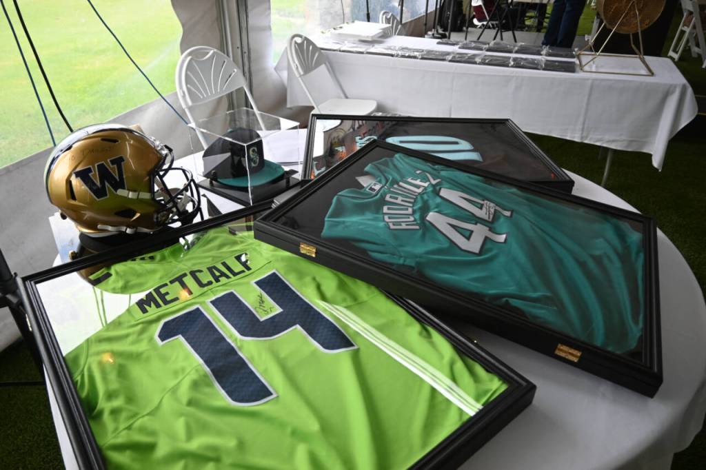 Sequim Gazette photo by Michael Dashiell / Live auction items at the 2024 Sequim Athletic Hall of Fame event on Sept. 14 included signed jerseys from Julio Rodriguez and DK Metcalf.