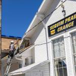 Photo courtesy of Sherrie Cerutti
BMC Roofing crew members place new shingles on Aug. 30 atop the Sequim Prairie Grange.