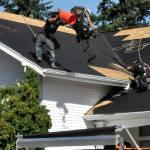 Sequim Gazette photo by Matthew Nash/ BMC Roofing crews work on Aug. 28 to replace a portion of the roof of the Sequim Prairie Grange. It should be completed early this week.