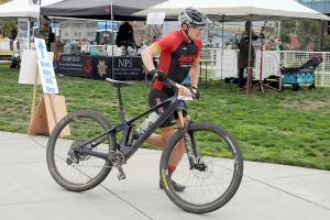 Calvin Colander of Bellingham-based Team Improbability Drive heads for the handoff after finishing the mountain bike leg of the 2023 Big Hurt in Port Angeles. (Keith Thorpe/Peninsula Daily News)