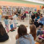Photo courtesy of North Olympic Library System / At left, Charlotte McGrew  youth services librarian for the North Olympic Library System, leads a Family Storytime program. Free fall programs for all ages begin in September at the Sequim Library.